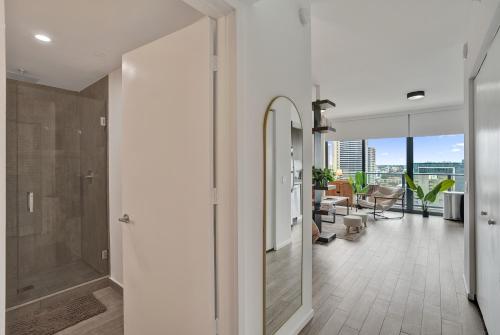 a bathroom with a walk in shower and a glass door at Cadenza Miami - Luxury Residences in Miami