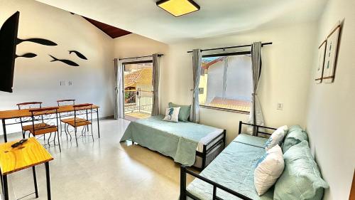 En eller flere senge i et værelse på Alto Loft Geribá