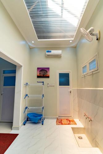 a bathroom with a toilet and a skylight at KKJ House in Zanzibar City
