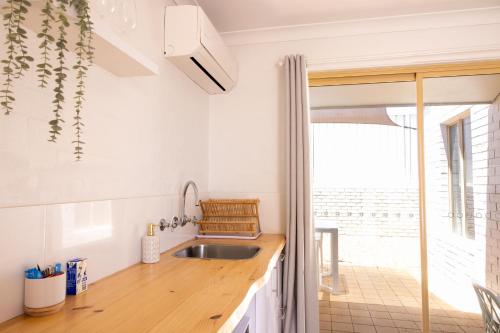 a kitchen with a sink and a counter top at The African Reef in Geraldton