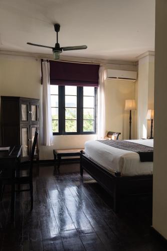Llit o llits en una habitació de Hotel Khamvongsa