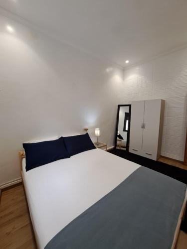 a bedroom with a large white bed with blue pillows at Central Tangier , 3xBedroom , Apartment, Historic Medina, Margarita in Tangier
