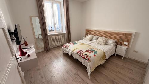 a bedroom with a bed and a desk and a window at Trento Living in Trento