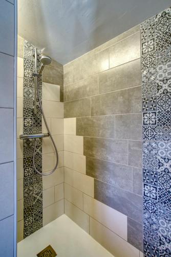 a bathroom with a shower with a glass door at Cottage les Marjoris Tanneron in Tanneron