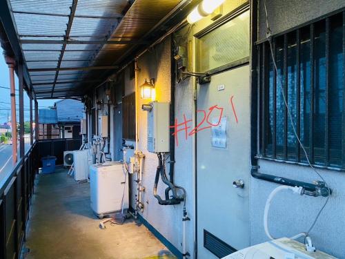a train car with graffiti on the side of it at Shirakkan - Vacation STAY 16295 in Hamura
