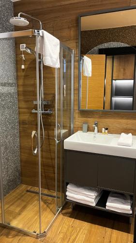 a bathroom with a sink and a shower at Modern Mountain Mystic Kolasin in Kolašin