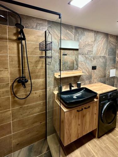 a bathroom with a sink and a shower at Rekreační dům Dobšín in Dobšín