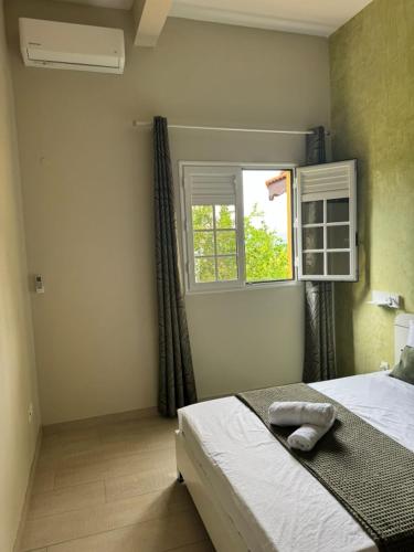 a bedroom with a bed and a window at Villa DAV'ANGEL in Le Lamentin