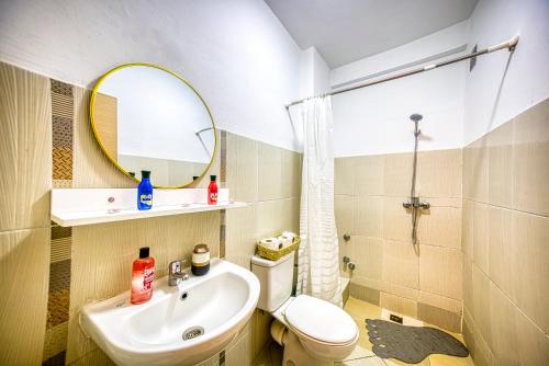a bathroom with a sink and a toilet and a mirror at Appartement saada Agadir in Agadir