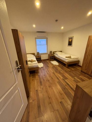 a room with two beds in it with a door at Schildetal Apartment 1 in Camin
