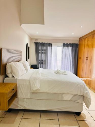 En eller flere senge i et værelse på Sanlou - Southport