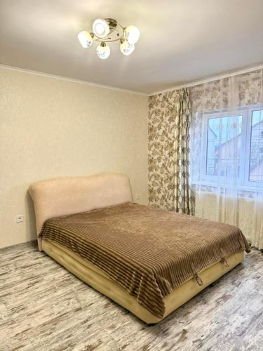 a bed in a room with a window at Будинок в Мукачево in Mukacheve