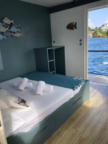a bed in a room with a view of the water at Aqua Lodge, Les Saintes, Terre de Haut, Guadeloupe in Terre-de-Haut