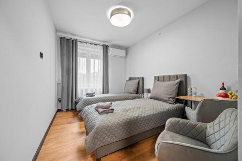 En eller flere senge i et værelse på Centrum Prime Apartments