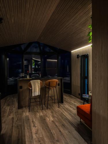 a kitchen with two chairs and a counter in a room at Lyngen Aurora Resort in Koppangen