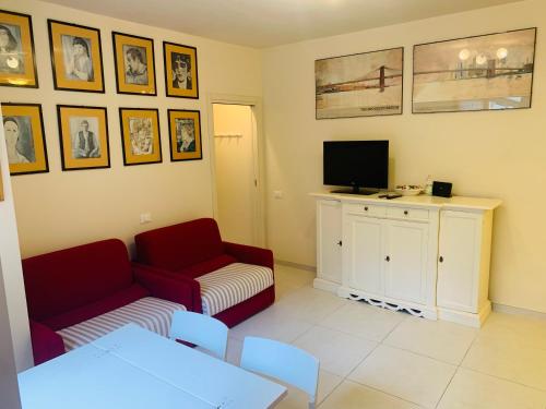 a living room with a couch and a tv at LucevanLeStelle - Full Comfort Quiet Apartment by the Promenade in Viareggio