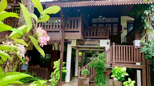 a building with a balcony with plants in front of it at SJ House in Chiang Mai