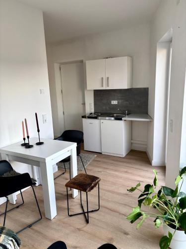 een keuken met een witte tafel en een witte tafel en stoelen bij Moderne Ferienwohnung nahe Bostalsee in Nohfelden