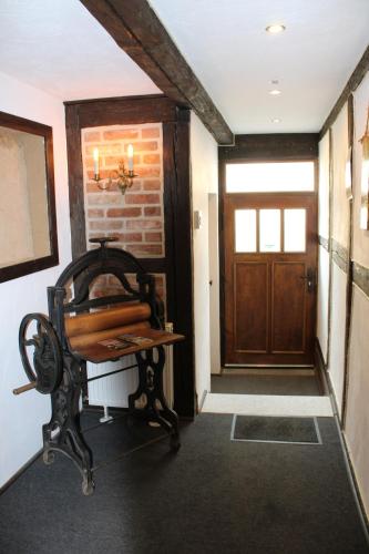 a hallway with a wooden door and a wooden bench at Schöne Ecke 13 in Wernigerode