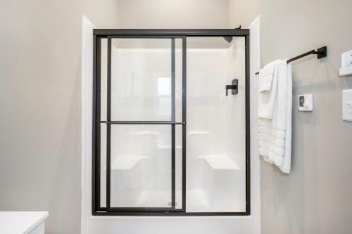 a shower with a glass door in a bathroom at Carolina Camp Cedar in Pickens