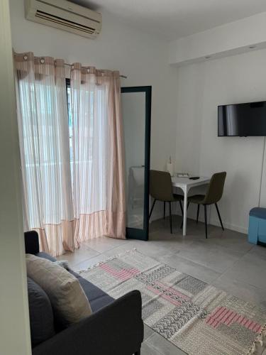 a living room with a couch and a table at Canavial Terrace@Heart of Funchal in Funchal