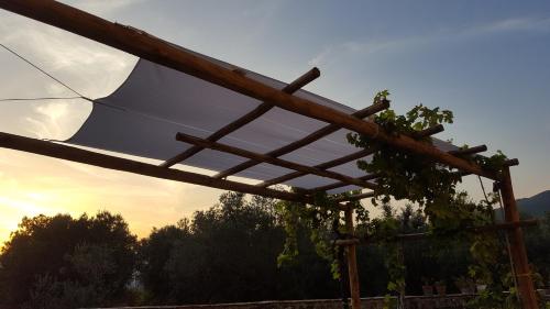 a wooden pergola with an umbrella on it at La Tortora in Fisciano