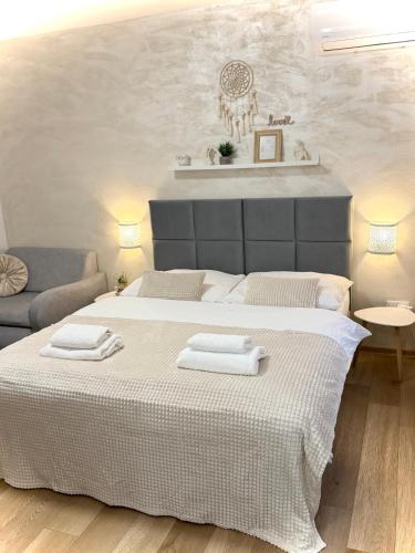 a bedroom with a large bed with two towels on it at Apartmány ZELENÝ DOM in Podhájska