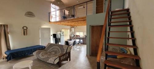 a living room with a staircase and a dining room at La Sietecolores in Toay