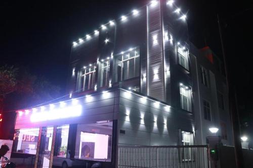 a building with lights on top of it at night at The Inspira Hotel Haridwar in Haridwār