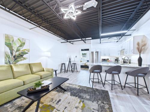 a living room with a couch and a table at Sleek Coastal Loft Close to Port & Beach -Unit 205 in Cape Canaveral