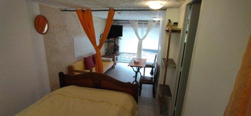 a small room with a bed and a window at Studio La Cheneraie in Bargemon