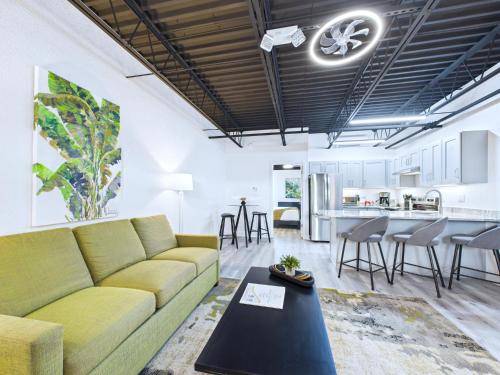 a living room with a couch and a table at Sleek Coastal Loft Close to Port & Beach -Unit 205 in Cape Canaveral
