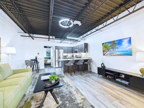 a living room with a couch and a table at Loft Getaway Near Port & Beach -Unit 203 in Cape Canaveral
