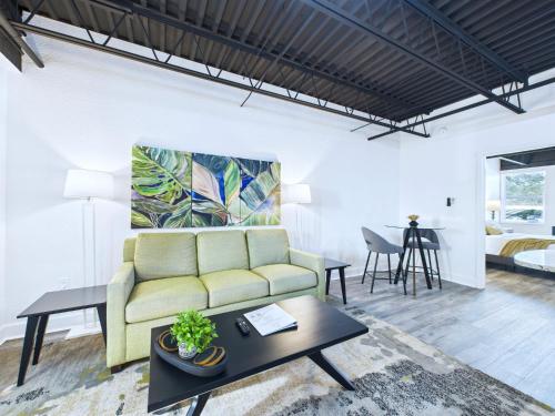 a living room with a couch and a bedroom at Loft Getaway Near Port & Beach -Unit 203 in Cape Canaveral