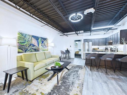 a living room with a couch and a kitchen at Loft Getaway Near Port & Beach -Unit 203 in Cape Canaveral