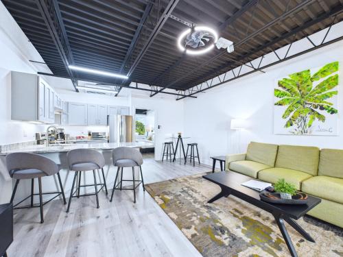 a living room with a couch and a table at Chic Loft Retreat Near Port Canaveral -Unit 202 in Cape Canaveral