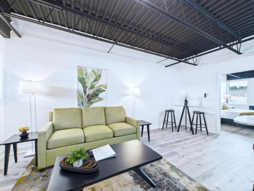 a living room with a couch and a table at Modern Loft near Port, Beach, & Dining -Unit 201 in Cape Canaveral
