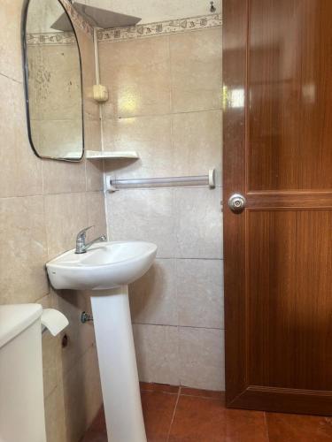 a bathroom with a sink and a mirror at Flor de Lis Casa in La Paloma
