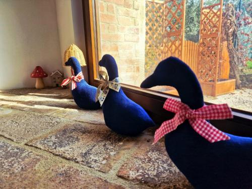 four rubber ducks tied to a door with a bow at Torre del Tempo in Torgiano