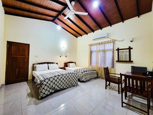 Postel nebo postele na pokoji v ubytování MG Resort - Yala