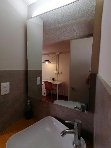 a bathroom with a sink and a mirror at Casagrande in San José de Malpaso