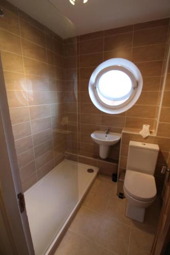 a bathroom with a toilet and a sink at Salisbury Renovated Apartment in Belfast