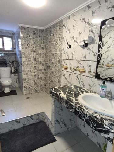 a bathroom with a sink and a toilet at Villa avec Piscine Meknes in Meknès