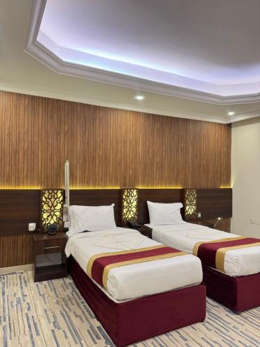 2 letti in camera con 2 letti e vista sul giardino di فندق اصيلة الاندلس a Muzdalifah