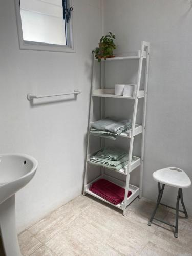 a white shelf in a bathroom with a sink at Loft Tongoy 3 Peninsula in Coquimbo