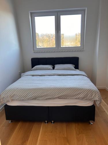 a large bed in a bedroom with a window at Bjelašnica by Samke in Bjelašnica