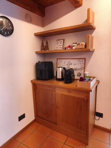 a counter in a room with a clock on the wall at Baitin Laf in Grosio