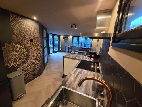 a kitchen with a sink and a counter top at Woodland Wellness Resort in Ermelo