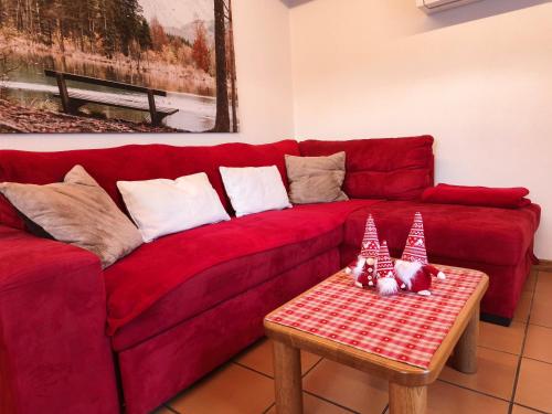 a red couch with a table in a living room at Baitin Laf in Grosio