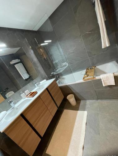 a bathroom with a sink and a bath tub at Carrousel Atlantic View in Rabat